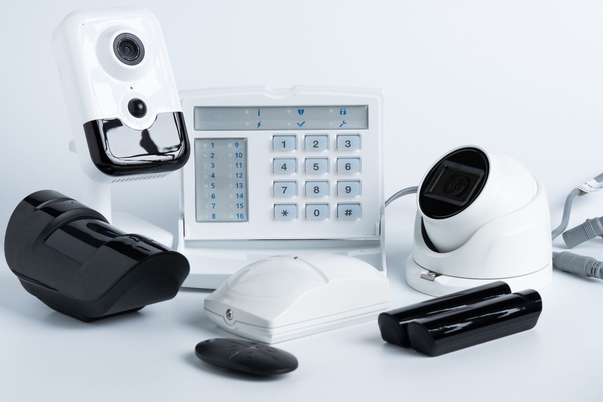 Various security system equipment on white background.