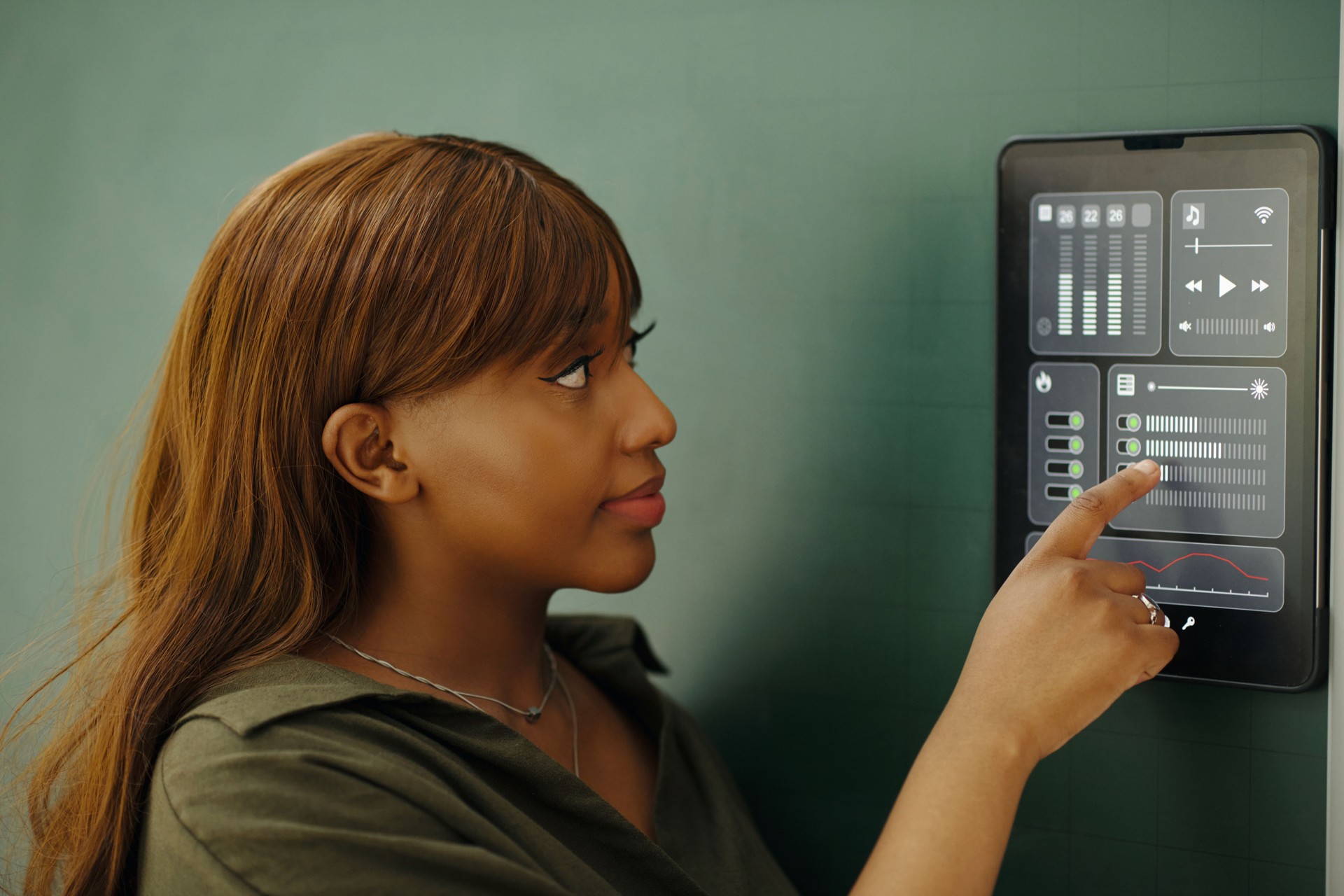 Engaging with Smart Home Control Panel on Wall Engaging with Smart Home Control Panel on Wall